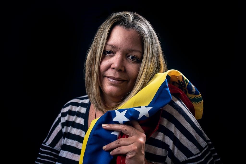 Porträt von der Menschenrechtspreisträgerin María Lourdes Afiuni mit der gelb blau rot gestreiftenFahne Venezuelas